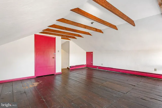 a room with wooden floor and an entryway