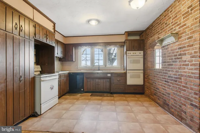 a large bathroom with a tub a sink and a large mirror