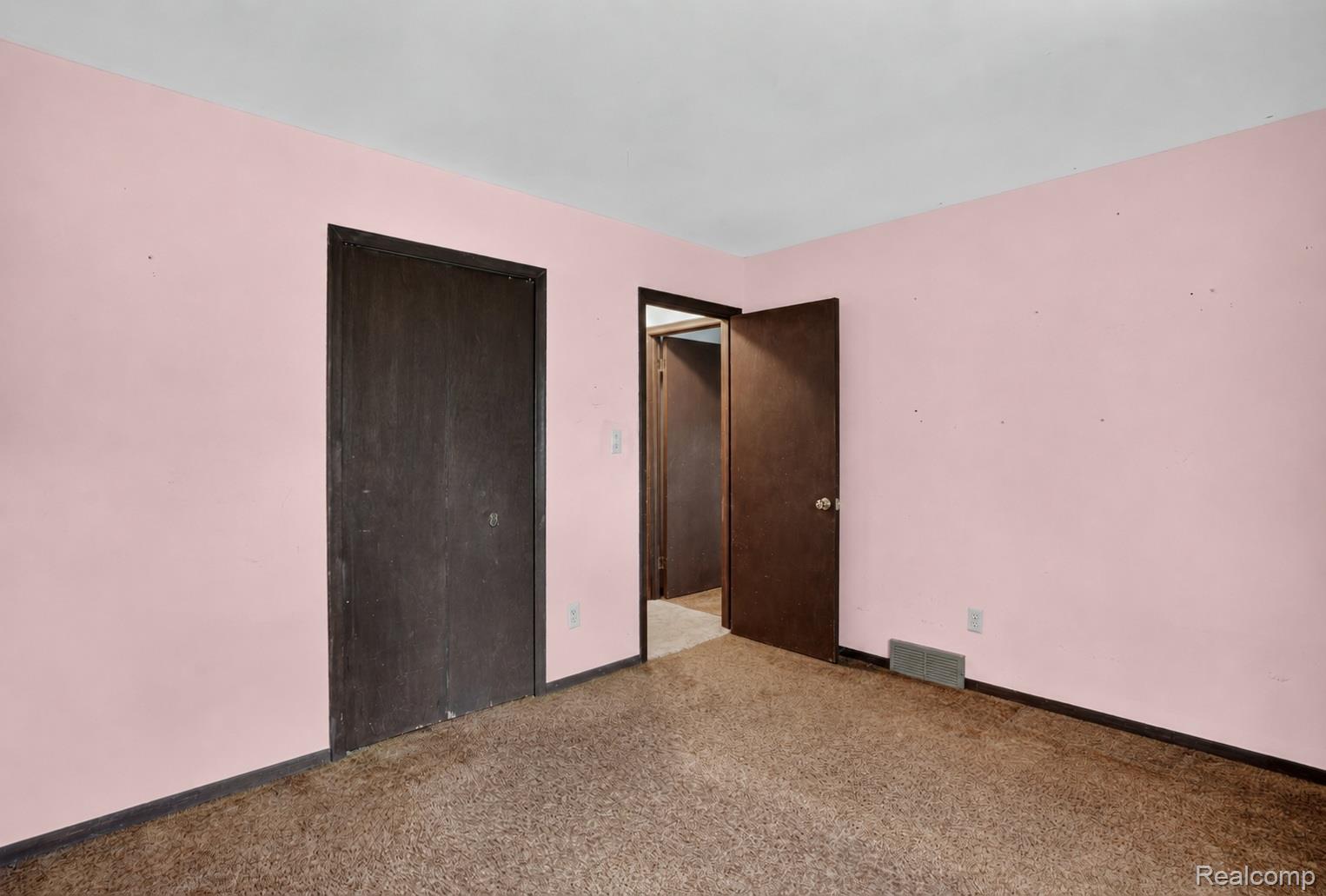 16955 English Road Manchester, MI 48158 - Photo 20 of 37 Room featuring light pink walls, brown carpeting, and dark wood-finish trim