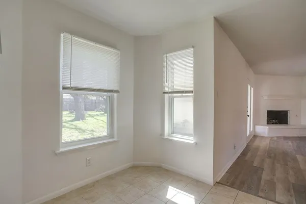 an empty room with windows and closet