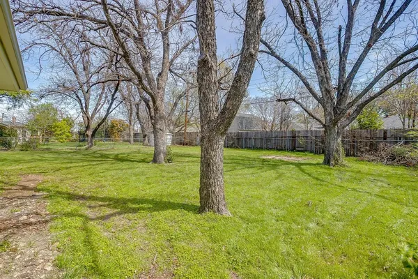 a view of a house with yard and tree s