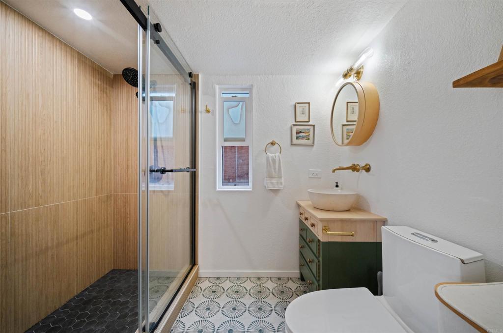 1624 North Coast Highway 101, Unit 45 Encinitas, CA 92024 - Photo 17 of 37 a bathroom with a sink toilet and shower