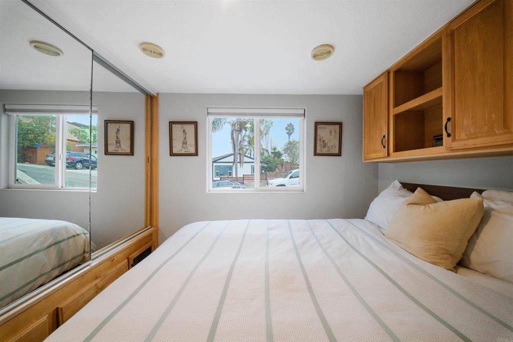 1624 North Coast Highway 101, Unit 45 Encinitas, CA 92024 - Photo 20 of 37 a bedroom with a bed and a window