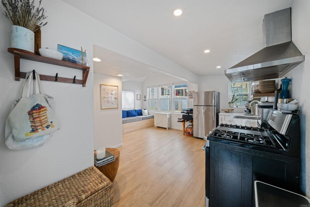 1624 North Coast Highway 101, Unit 45 Encinitas, CA 92024 - Photo 2 of 37 a room with furniture and a flat screen tv