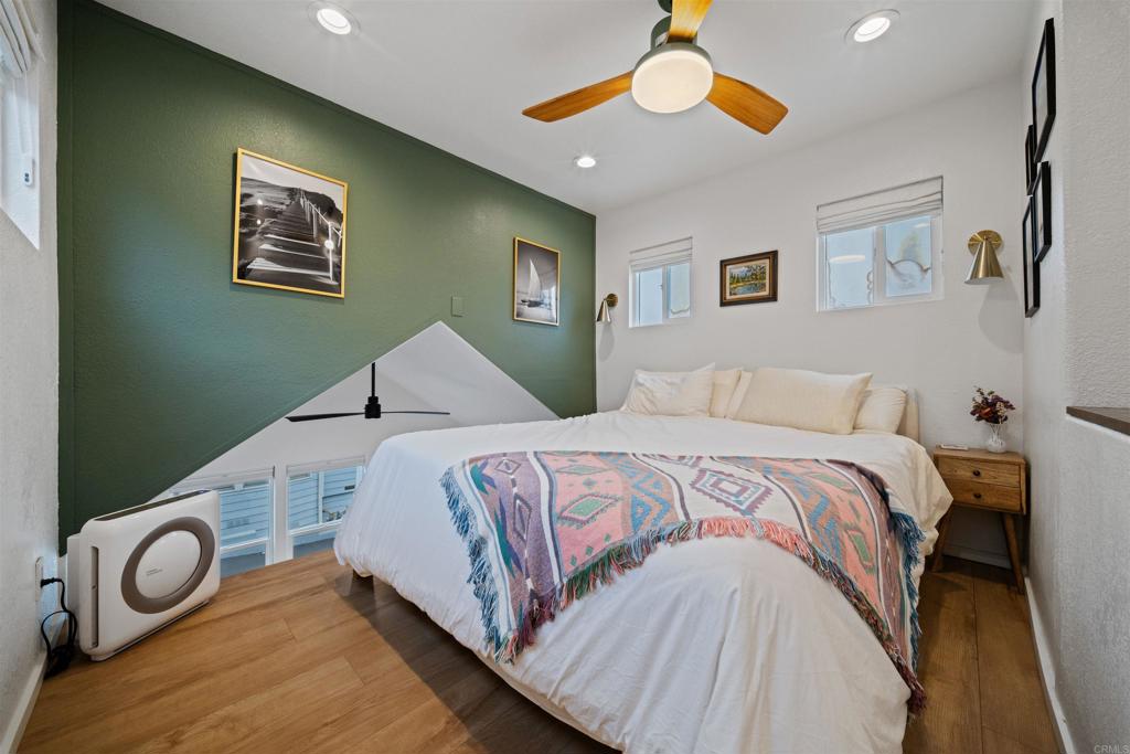 1624 North Coast Highway 101, Unit 45 Encinitas, CA 92024 - Photo 22 of 37 a bedroom with a bed and a painting on the wall