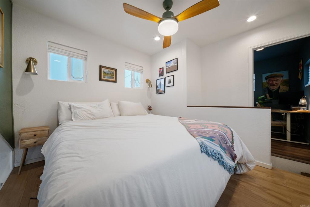 1624 North Coast Highway 101, Unit 45 Encinitas, CA 92024 - Photo 23 of 37 a bedroom with a bed and a flat tv screen on a dresser