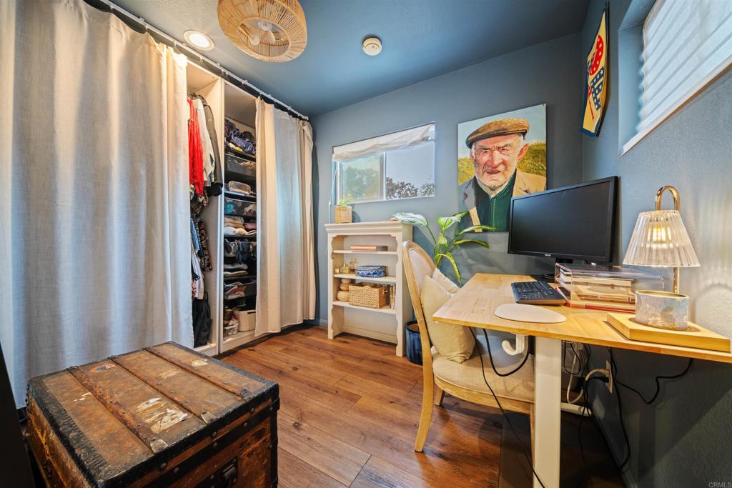 1624 North Coast Highway 101, Unit 45 Encinitas, CA 92024 - Photo 25 of 37 a view of a workspace with furniture and a flat screen tv