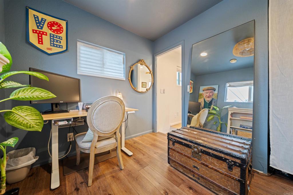 1624 North Coast Highway 101, Unit 45 Encinitas, CA 92024 - Photo 27 of 37 a living room with furniture and a wooden floor