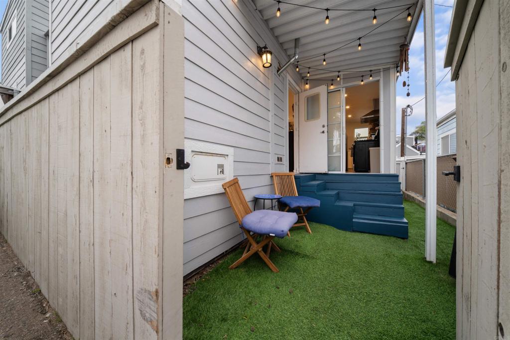 1624 North Coast Highway 101, Unit 45 Encinitas, CA 92024 - Photo 3 of 37 a view of a backyard with chairs and a swing