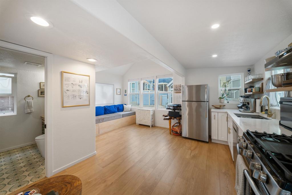 1624 North Coast Highway 101, Unit 45 Encinitas, CA 92024 - Photo 5 of 37 a living room with furniture and a wooden floor