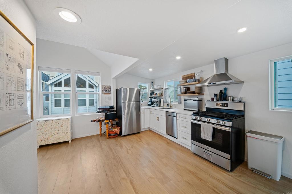 1624 North Coast Highway 101, Unit 45 Encinitas, CA 92024 - Photo 6 of 37 a kitchen with stainless steel appliances granite countertop a stove and a refrigerator