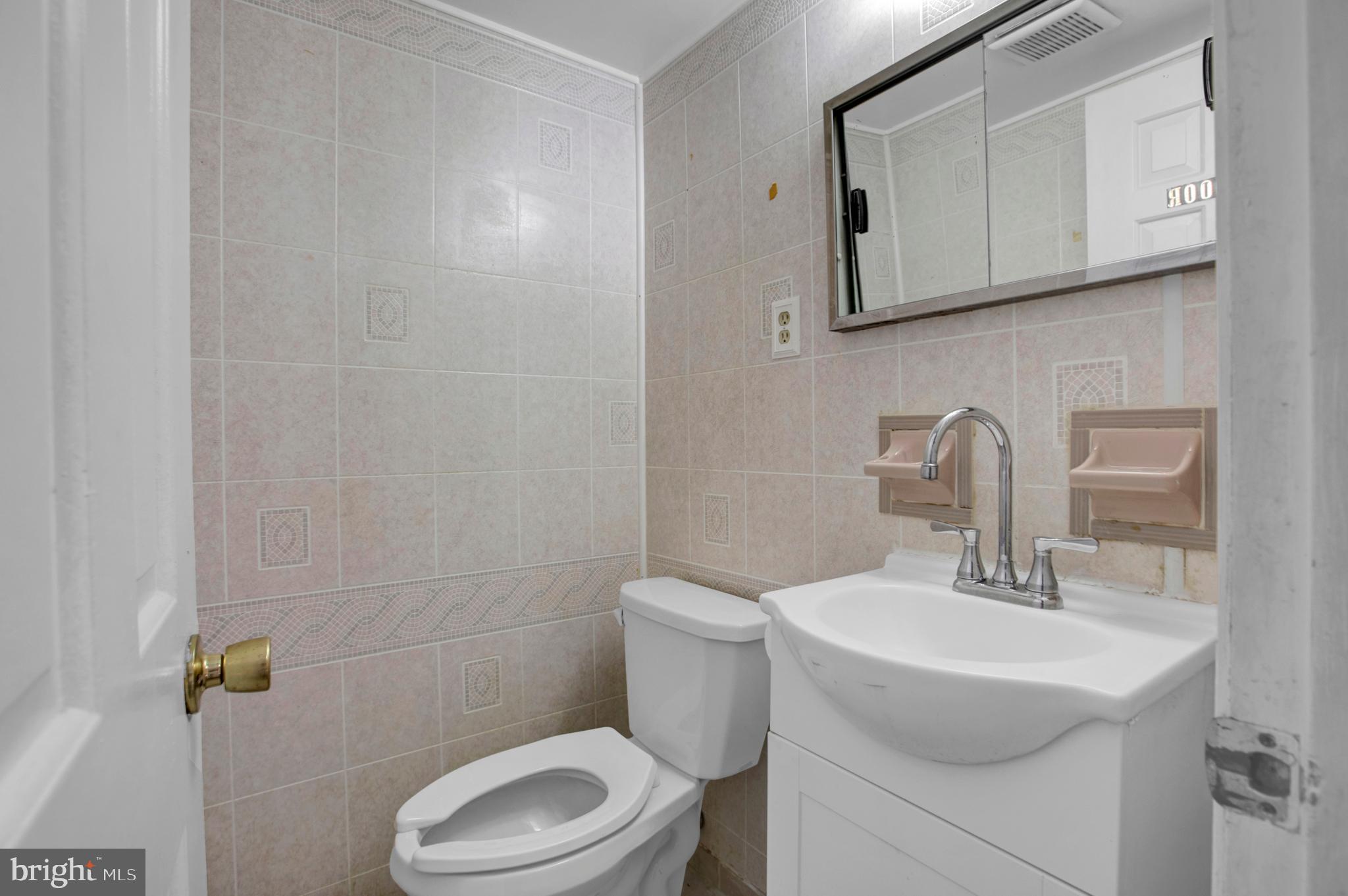 6811 Coolridge Road Temple Hills, MD 20748 - Photo 12 of 56 Half bath on main floor