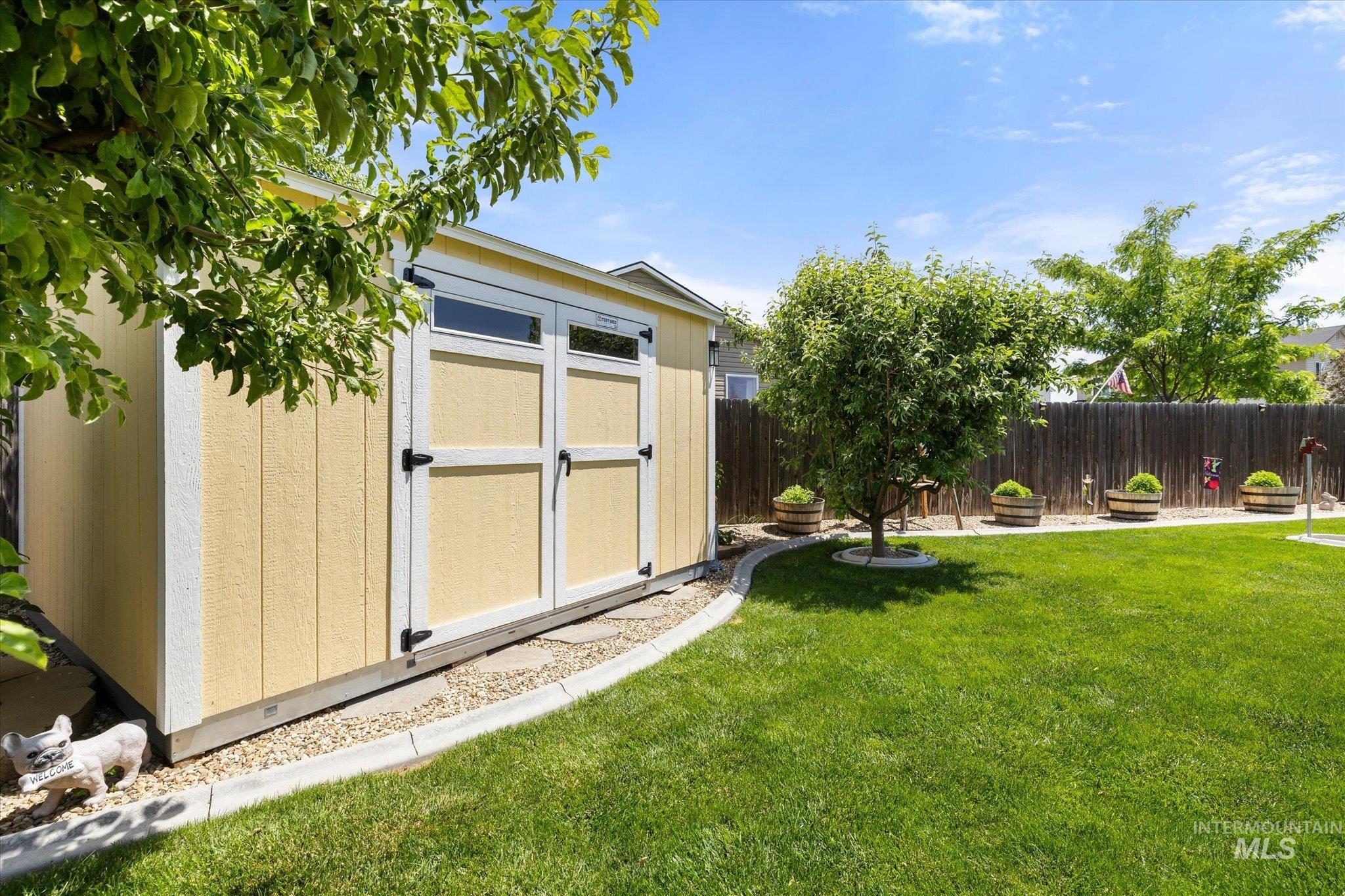 5401 Barkley Way Caldwell, ID 83607 - Photo 26 of 35 Backyard featuring a detached storage shed with double doors and transom windows