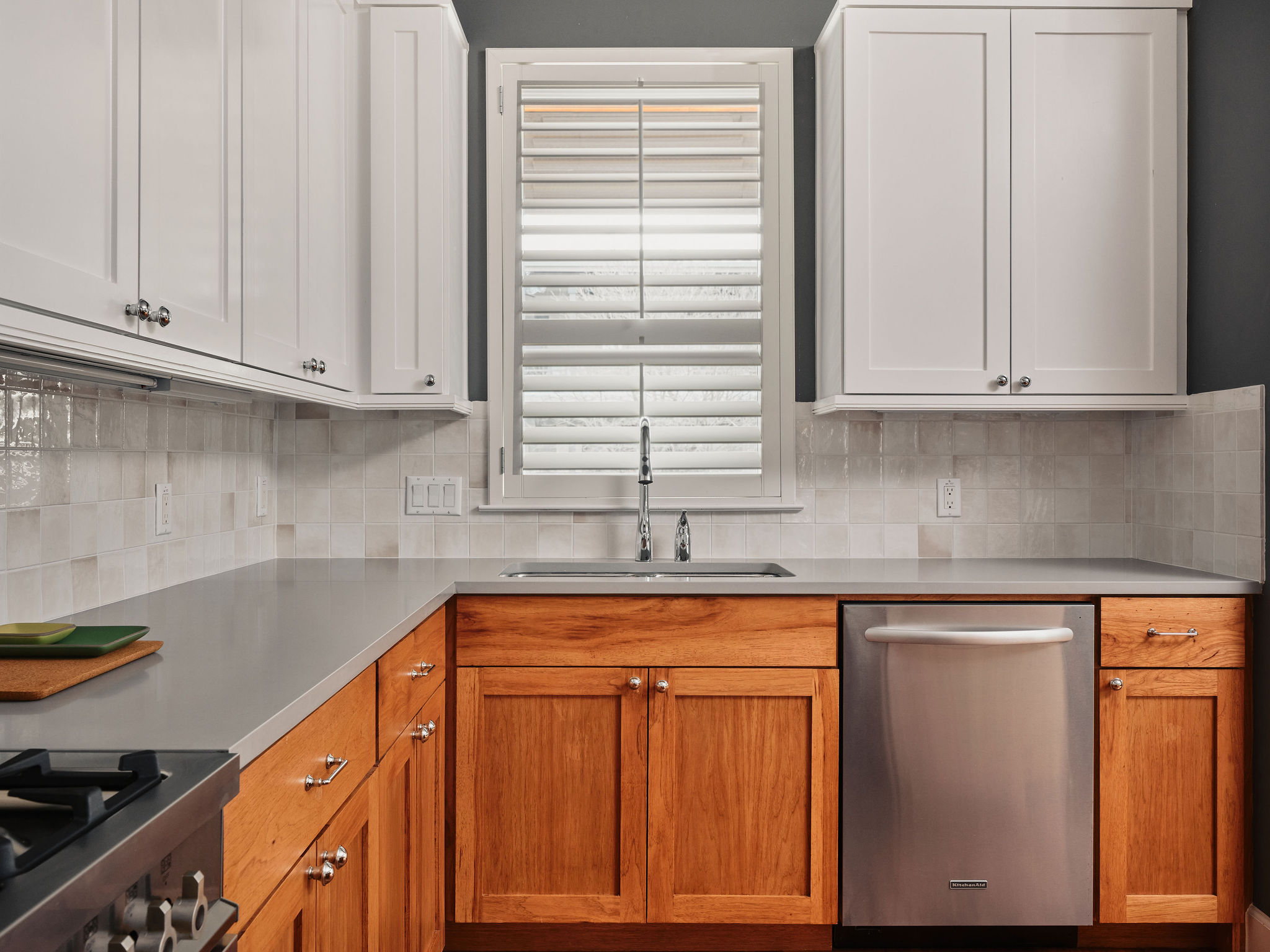 1504 Collier Street, Unit 4 Austin, TX 78704 - Photo 4 of 38 Kitchen featuring stainless steel appliances, light countertops, white cabinetry, and tasteful backsplash