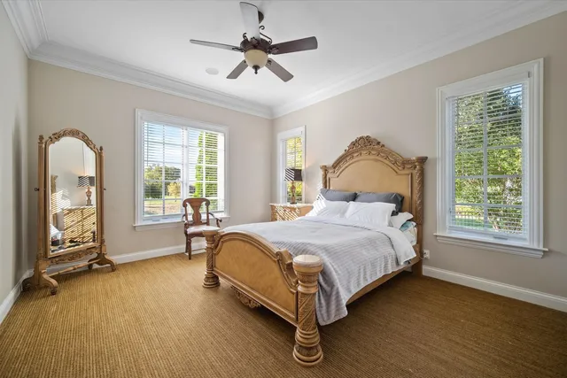 a bed sitting in a spacious bedroom next to a window