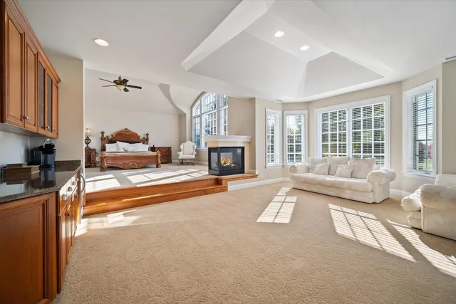 a living room with furniture large window and fireplace