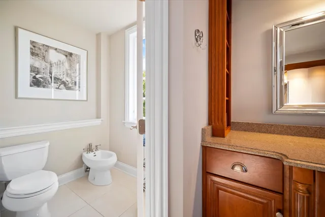 a bathroom with a toilet sink and mirror