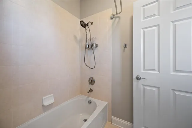 a bathroom with a bath tub with a shower