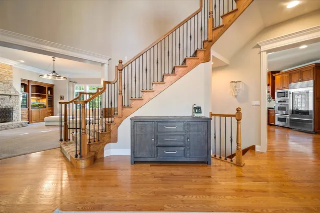 a view of entryway and hall with wooden floor