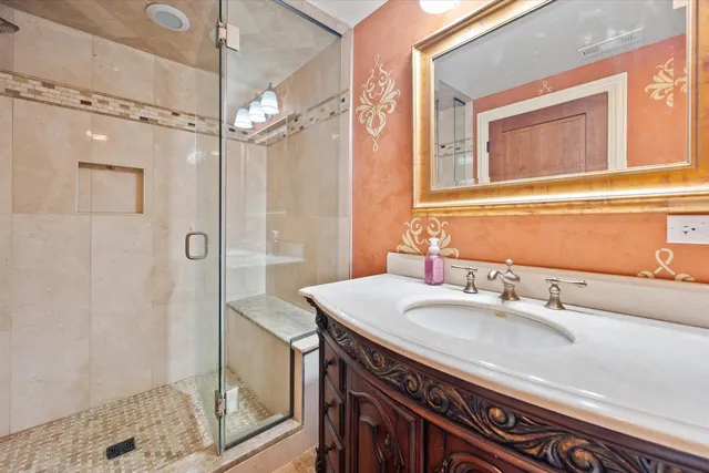 a bathroom with a sink a mirror and a shower