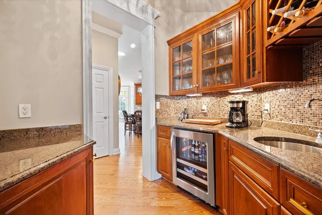 a kitchen with stainless steel appliances granite countertop a refrigerator and a sink