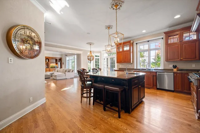 a kitchen with a table chairs a sink dishwasher window and cabinets