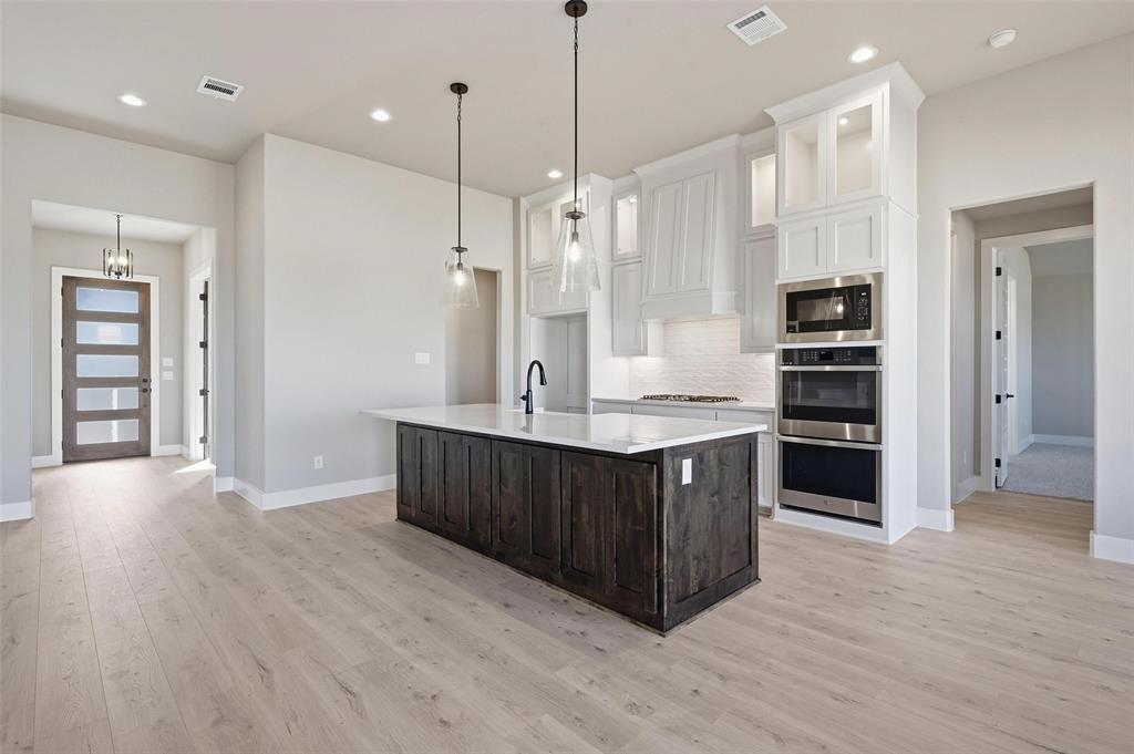 108 Rocky Top Azle, TX 76020 - Photo 6 of 40 a large kitchen with kitchen island a sink stainless steel appliances and cabinets