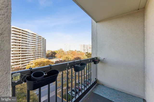 a living room with furniture a large window and chandelier