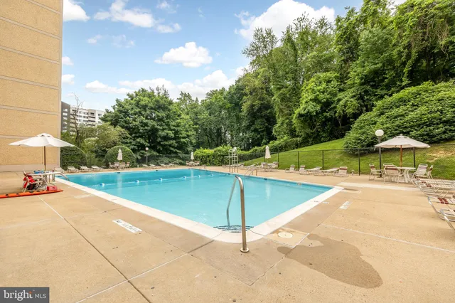 a view of a balcony with chairs and table