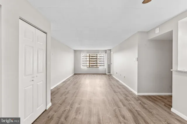 a living room with furniture a rug and a table