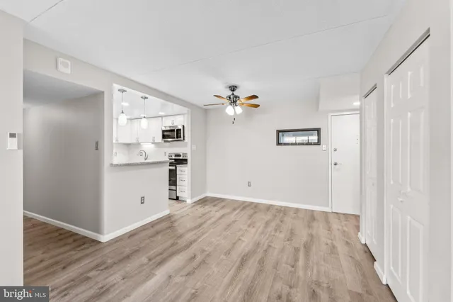 a view of a kitchen with a sink and a refrigerator