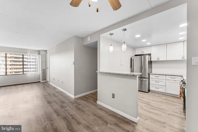 a kitchen with a stove sink and a refrigerator