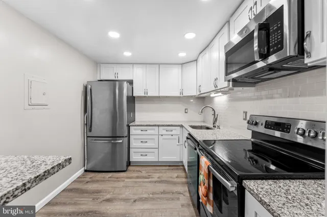 a kitchen with granite countertop a stove and a sink