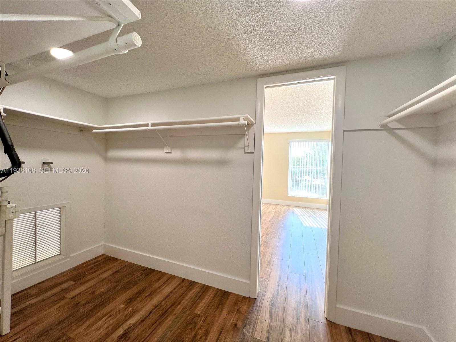 2160 Southwest 16th Avenue, Unit 314 Miami, FL 33145 - Photo 11 of 15 a view of empty room with wooden floor and fan