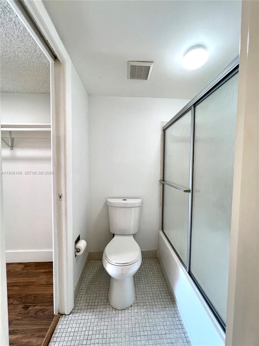 2160 Southwest 16th Avenue, Unit 314 Miami, FL 33145 - Photo 12 of 15 a bathroom with a toilet and a glass door shower