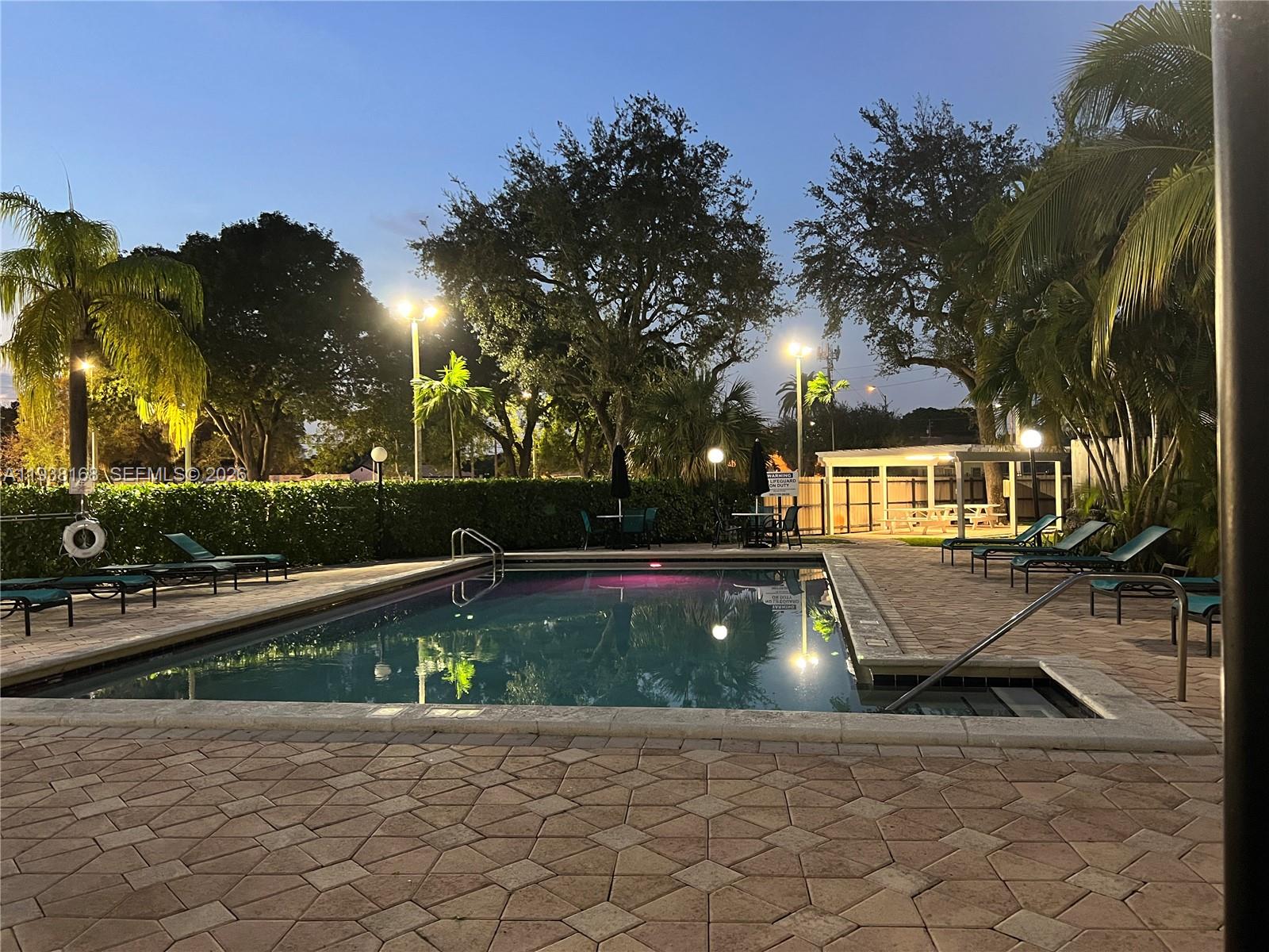 2160 Southwest 16th Avenue, Unit 314 Miami, FL 33145 - Photo 15 of 15 a view of a swimming pool with a patio and a yard