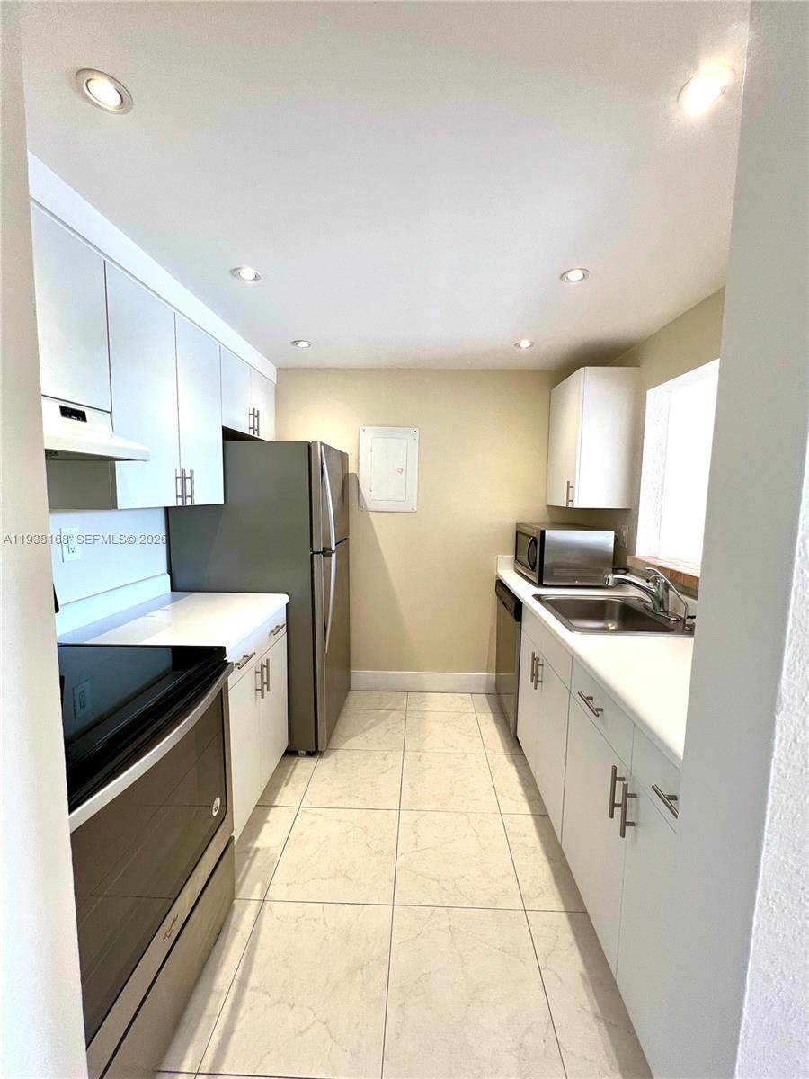 2160 Southwest 16th Avenue, Unit 314 Miami, FL 33145 - Photo 2 of 15 a large kitchen with a large counter top appliances and cabinets