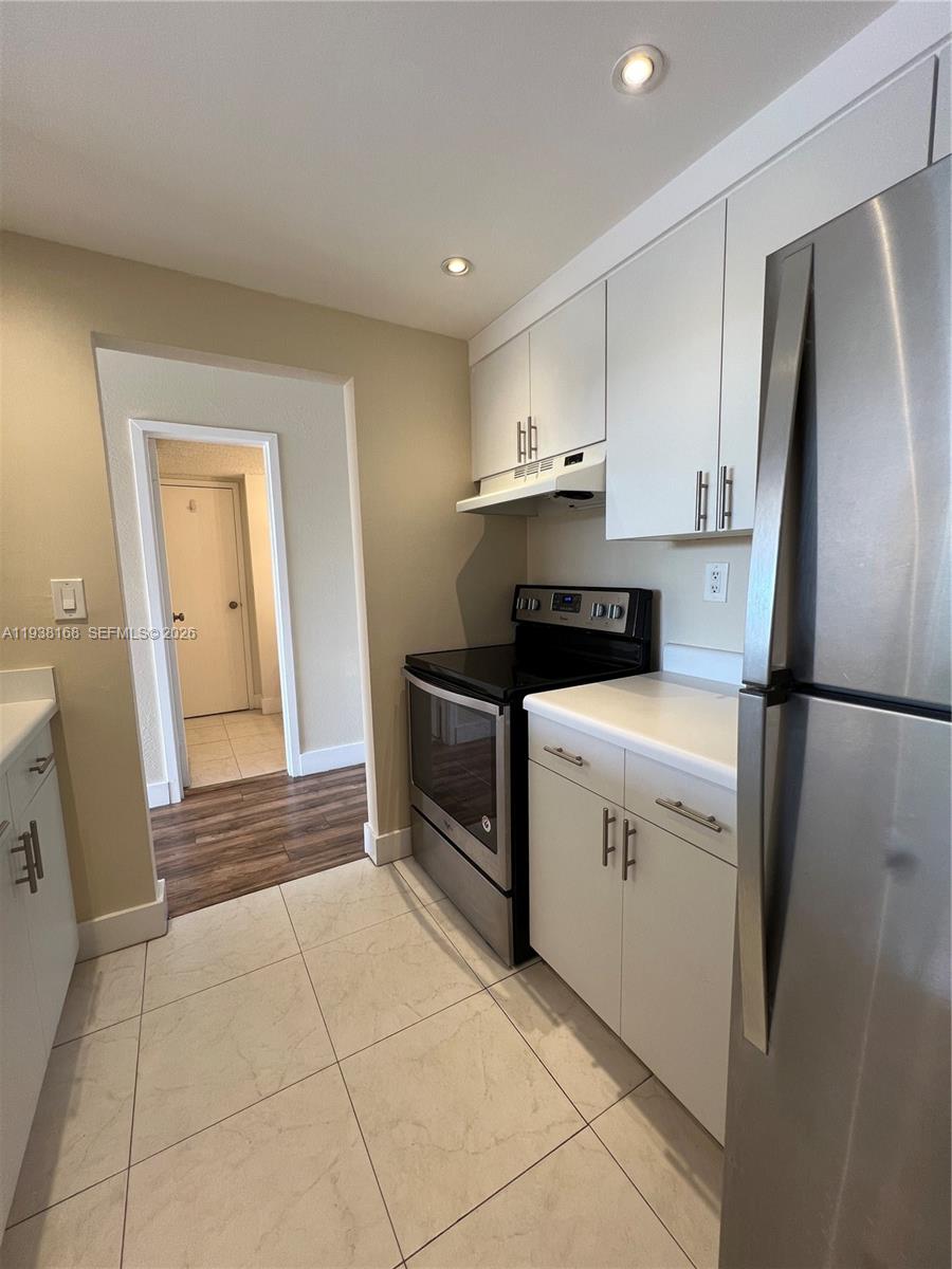 2160 Southwest 16th Avenue, Unit 314 Miami, FL 33145 - Photo 3 of 15 a kitchen with a refrigerator sink and cabinets