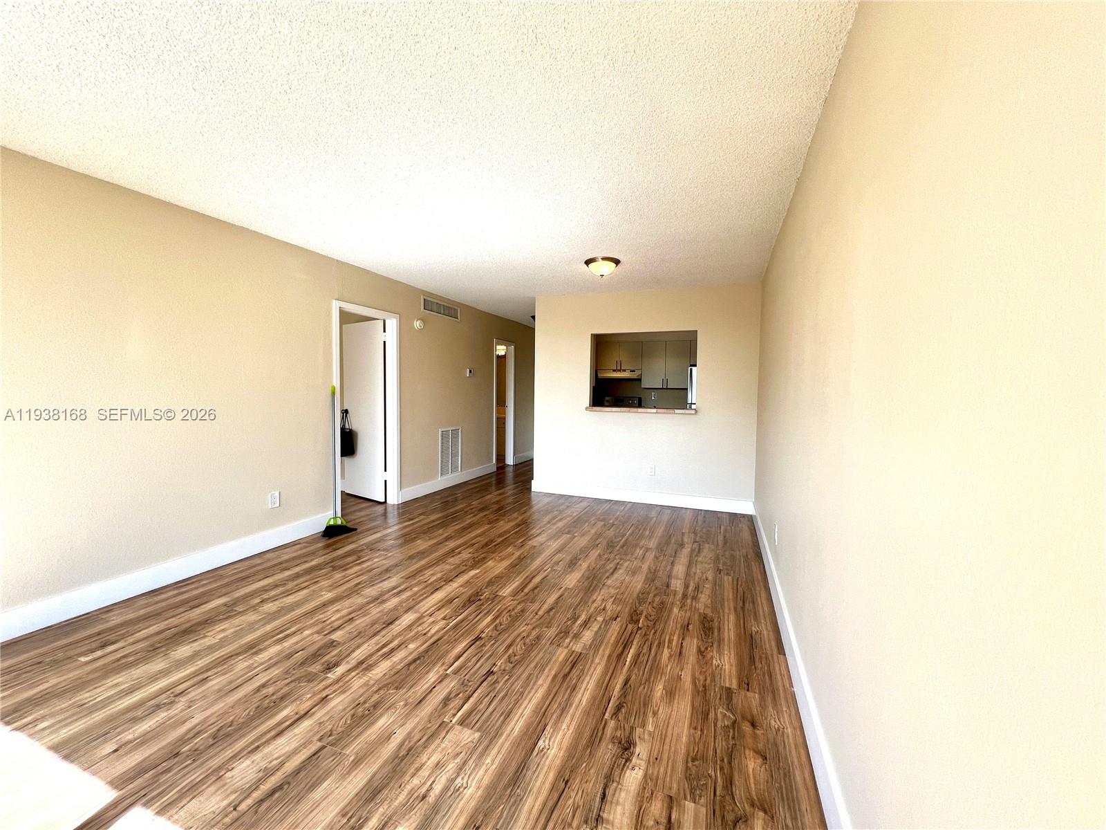 2160 Southwest 16th Avenue, Unit 314 Miami, FL 33145 - Photo 5 of 15 a view of an empty room with wooden floor