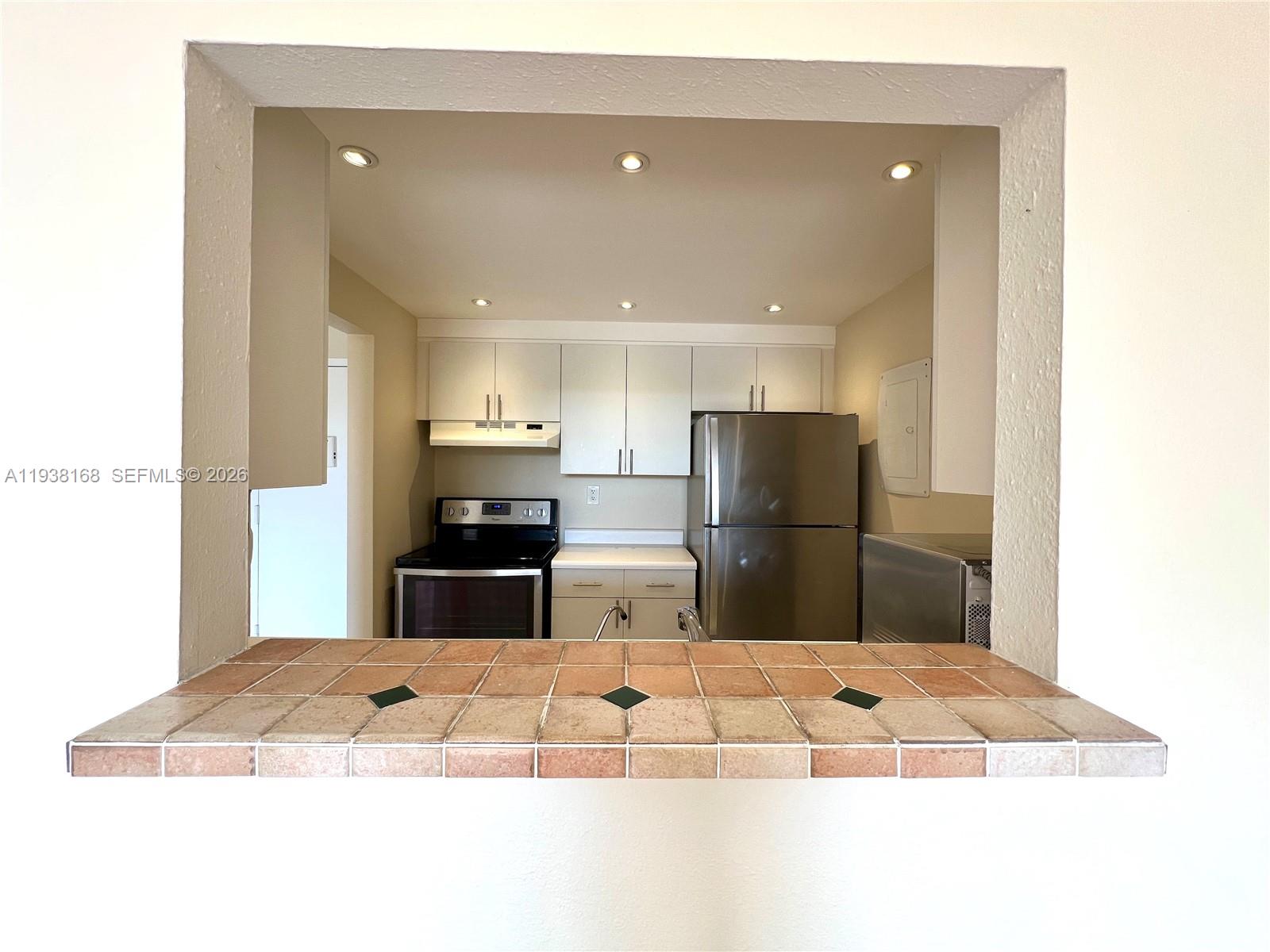 2160 Southwest 16th Avenue, Unit 314 Miami, FL 33145 - Photo 6 of 15 a kitchen with stainless steel appliances kitchen island granite countertop a refrigerator and a sink