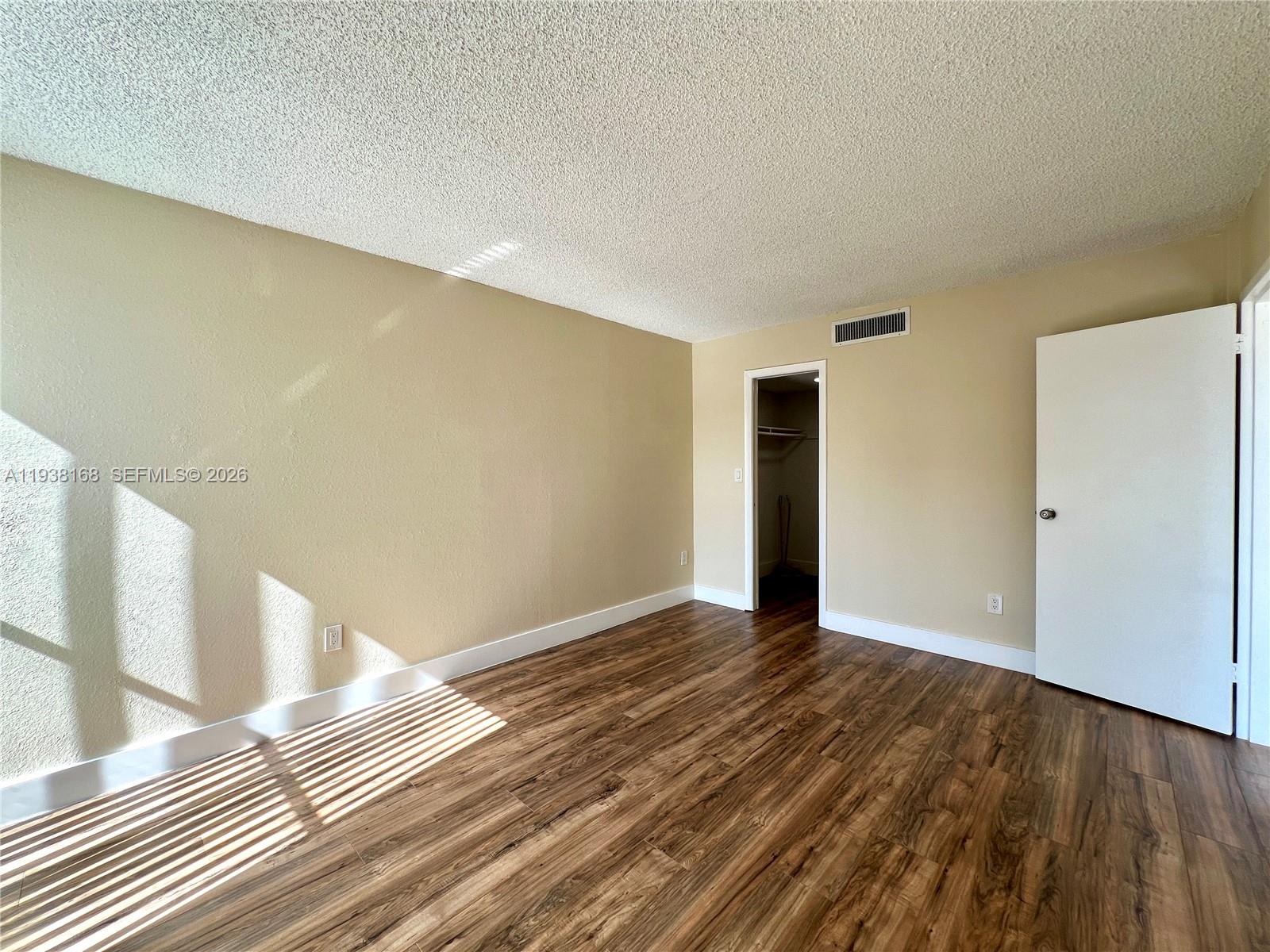2160 Southwest 16th Avenue, Unit 314 Miami, FL 33145 - Photo 9 of 15 a view of an empty room with wooden floor