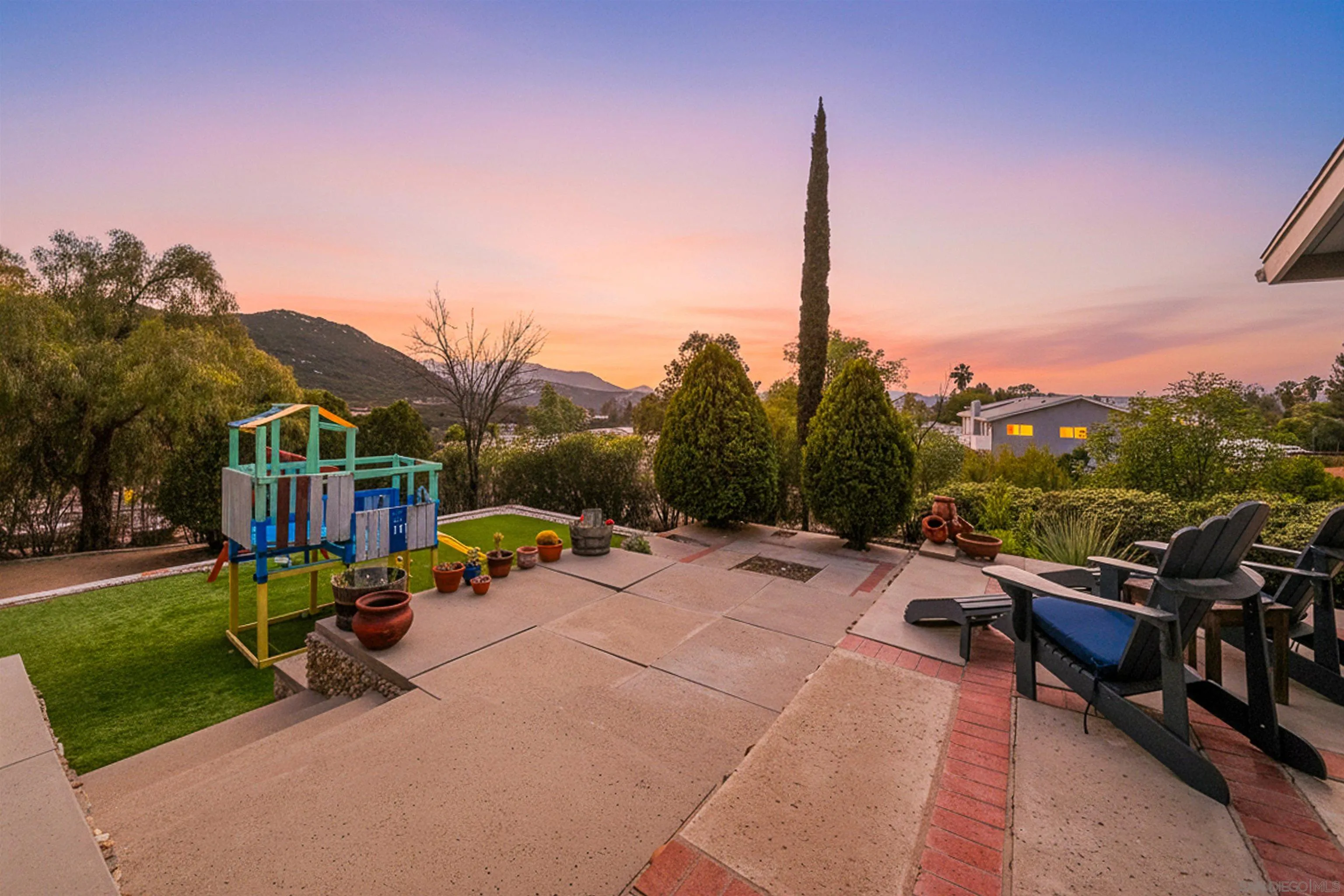 24563 Del Amo Road Ramona, CA 92065 - Photo 12 of 59 a view of a tennis ground with a table and chairs