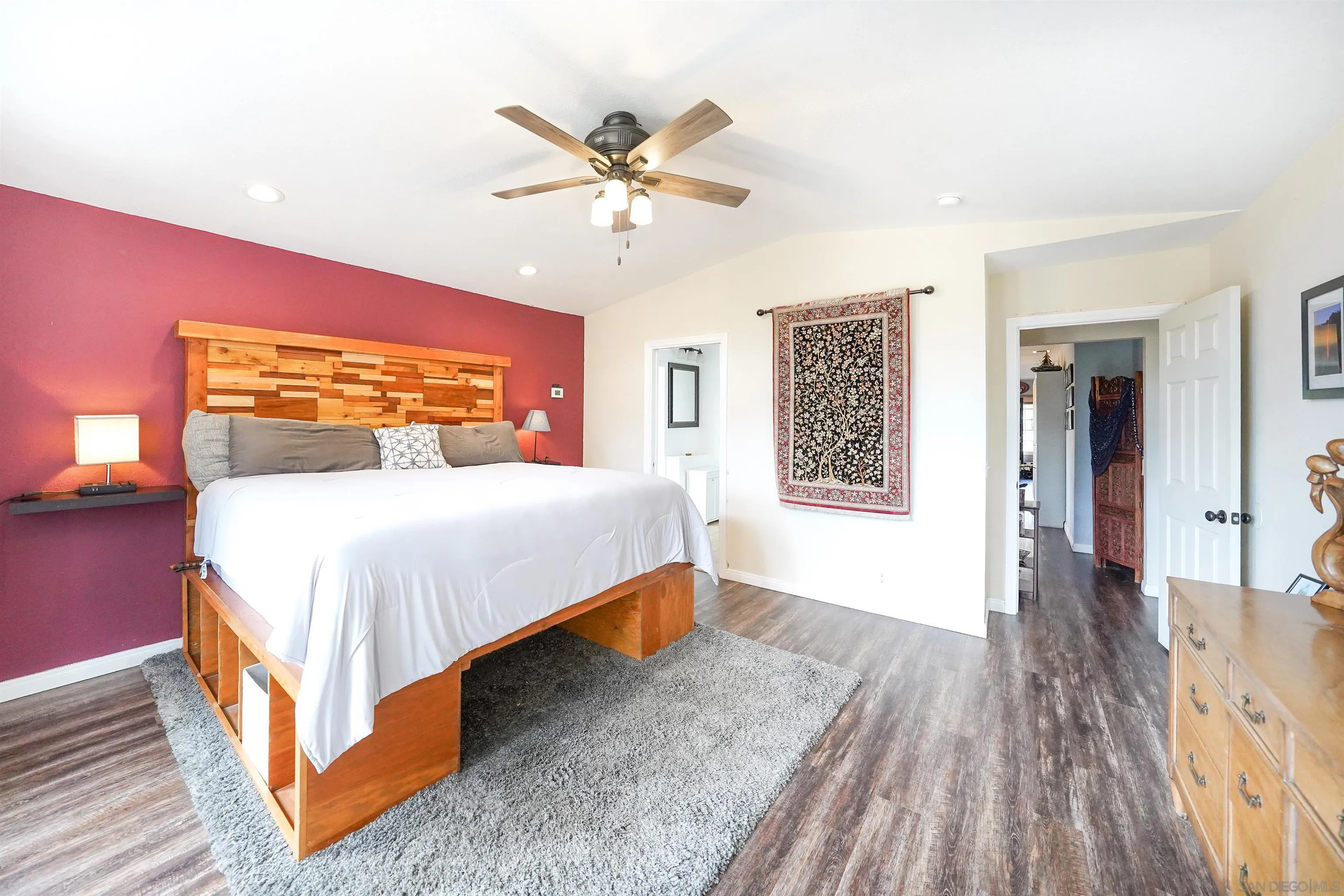 24563 Del Amo Road Ramona, CA 92065 - Photo 27 of 59 a bedroom with a bed and wooden floor