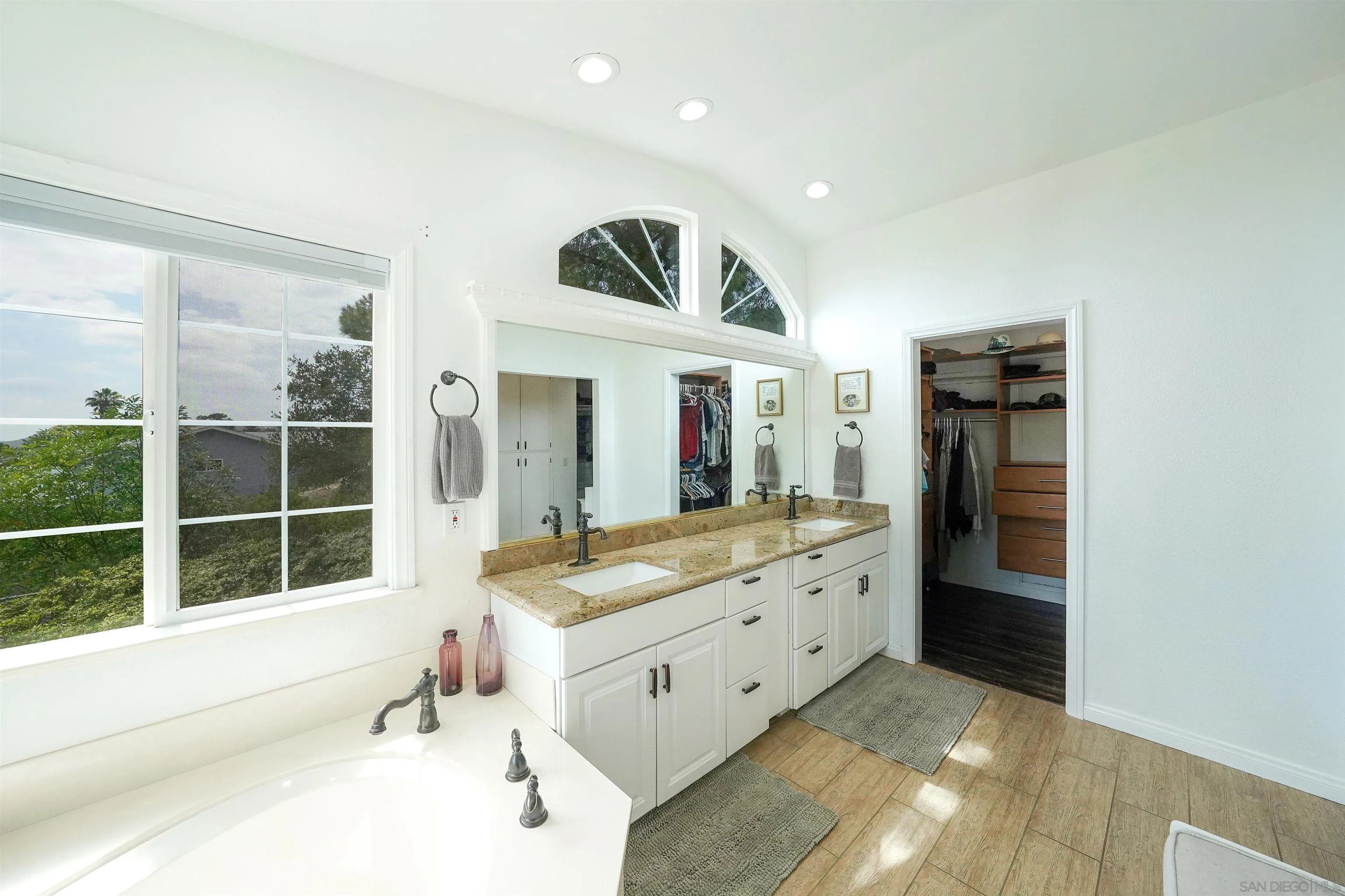 24563 Del Amo Road Ramona, CA 92065 - Photo 30 of 59 a bathroom with a sink and a large mirror