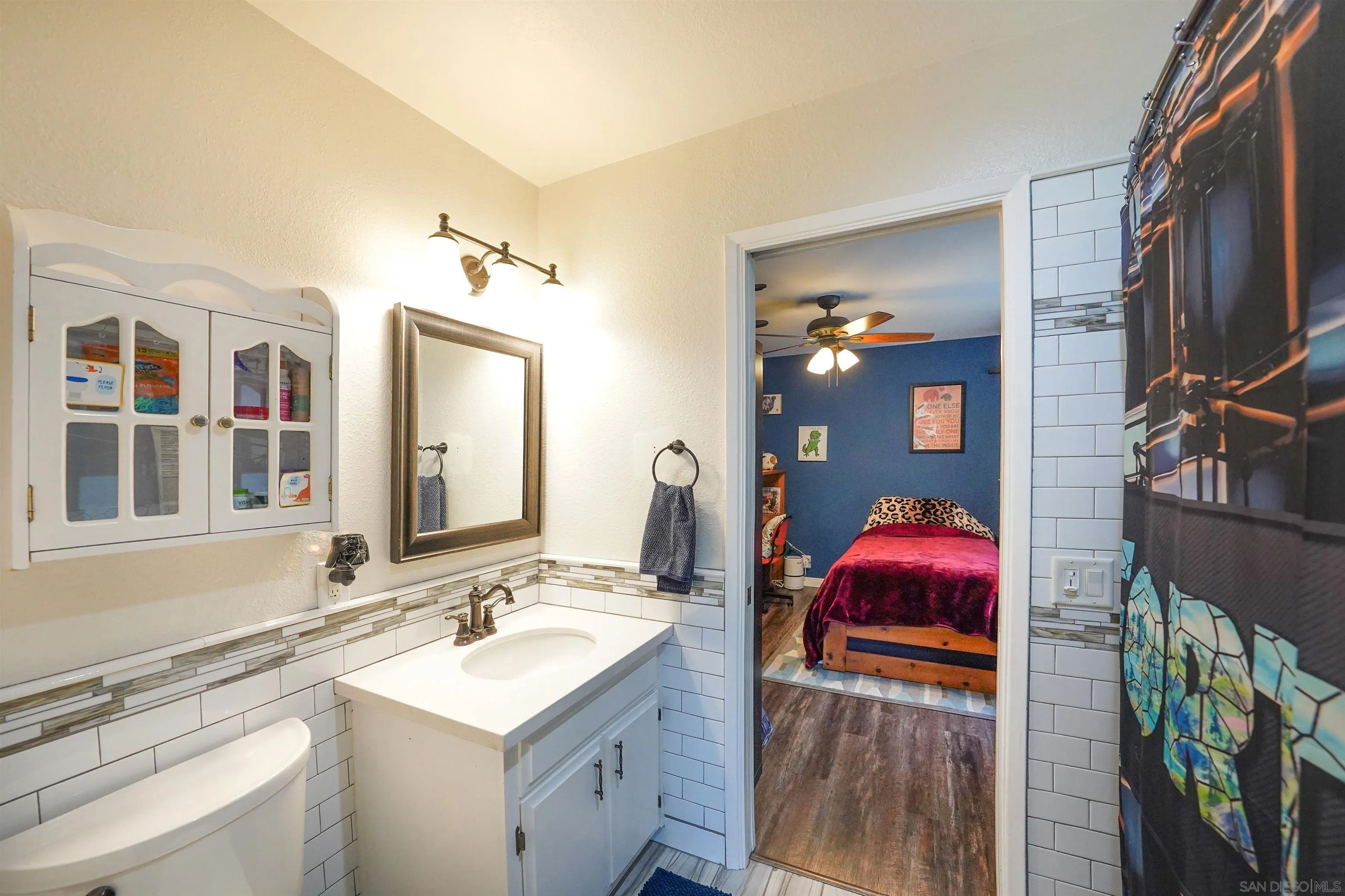 24563 Del Amo Road Ramona, CA 92065 - Photo 33 of 59 a bathroom with a sink vanity and a mirror