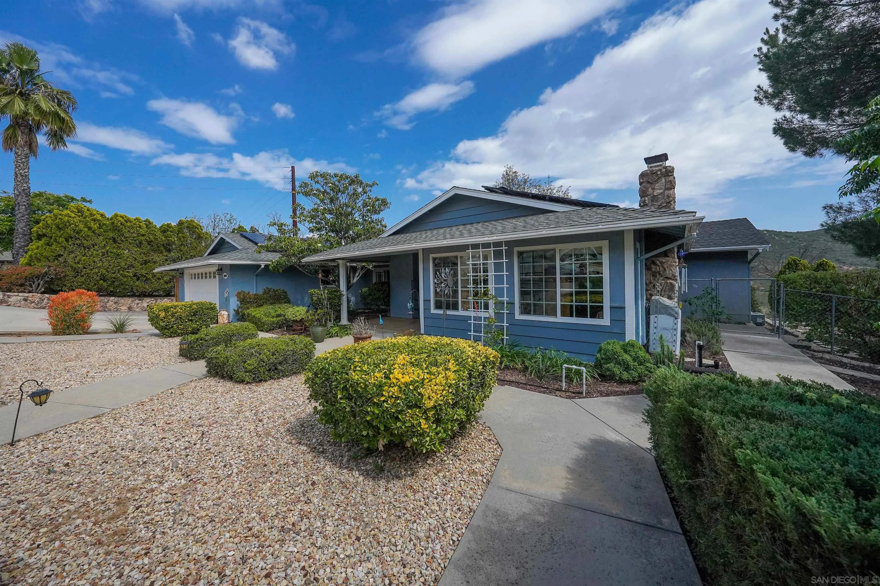 24563 Del Amo Road Ramona, CA 92065 - Photo 47 of 59 a front view of a house with a yard and potted plants