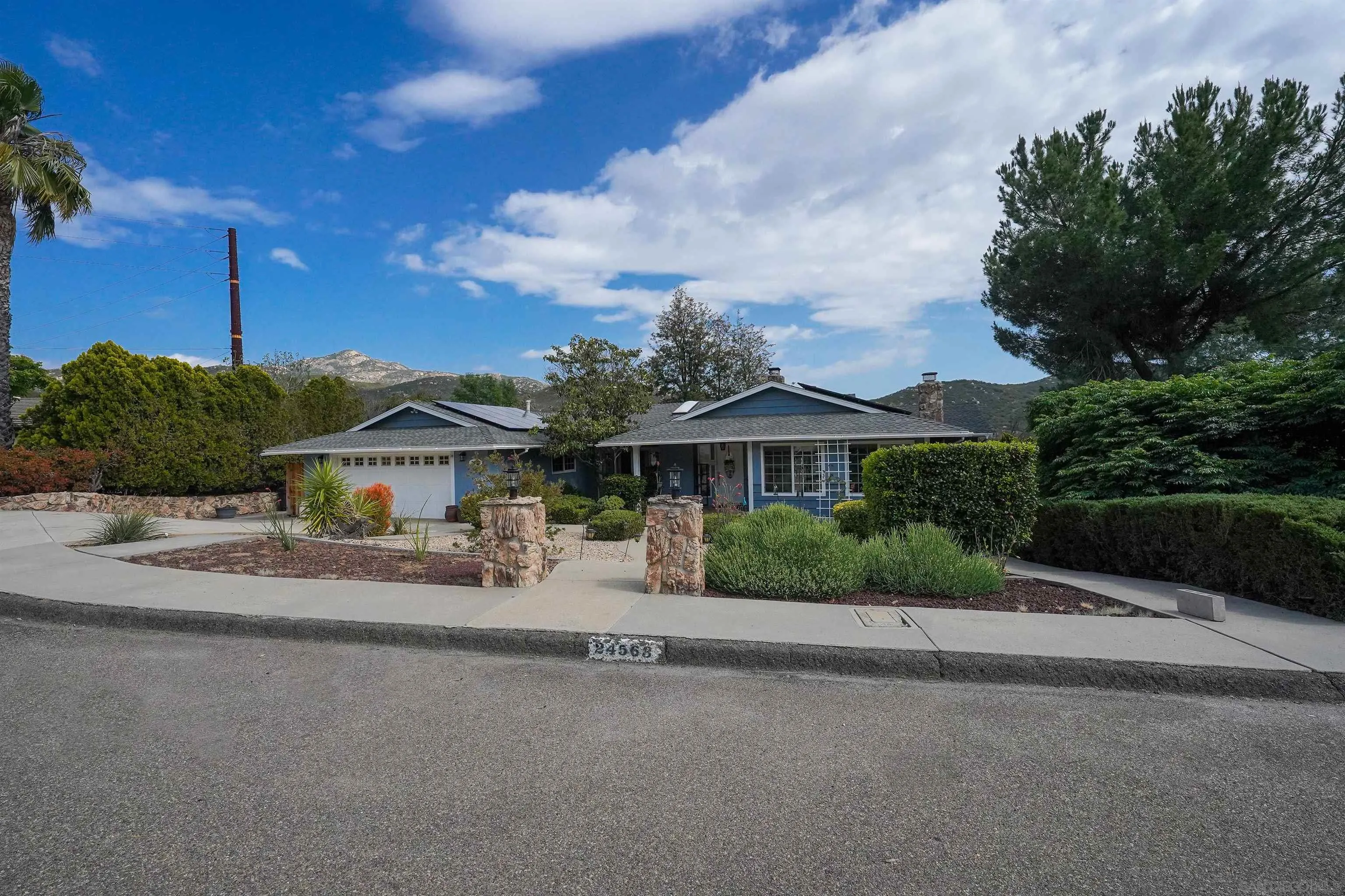 24563 Del Amo Road Ramona, CA 92065 - Photo 48 of 59 a front view of a house with a garden