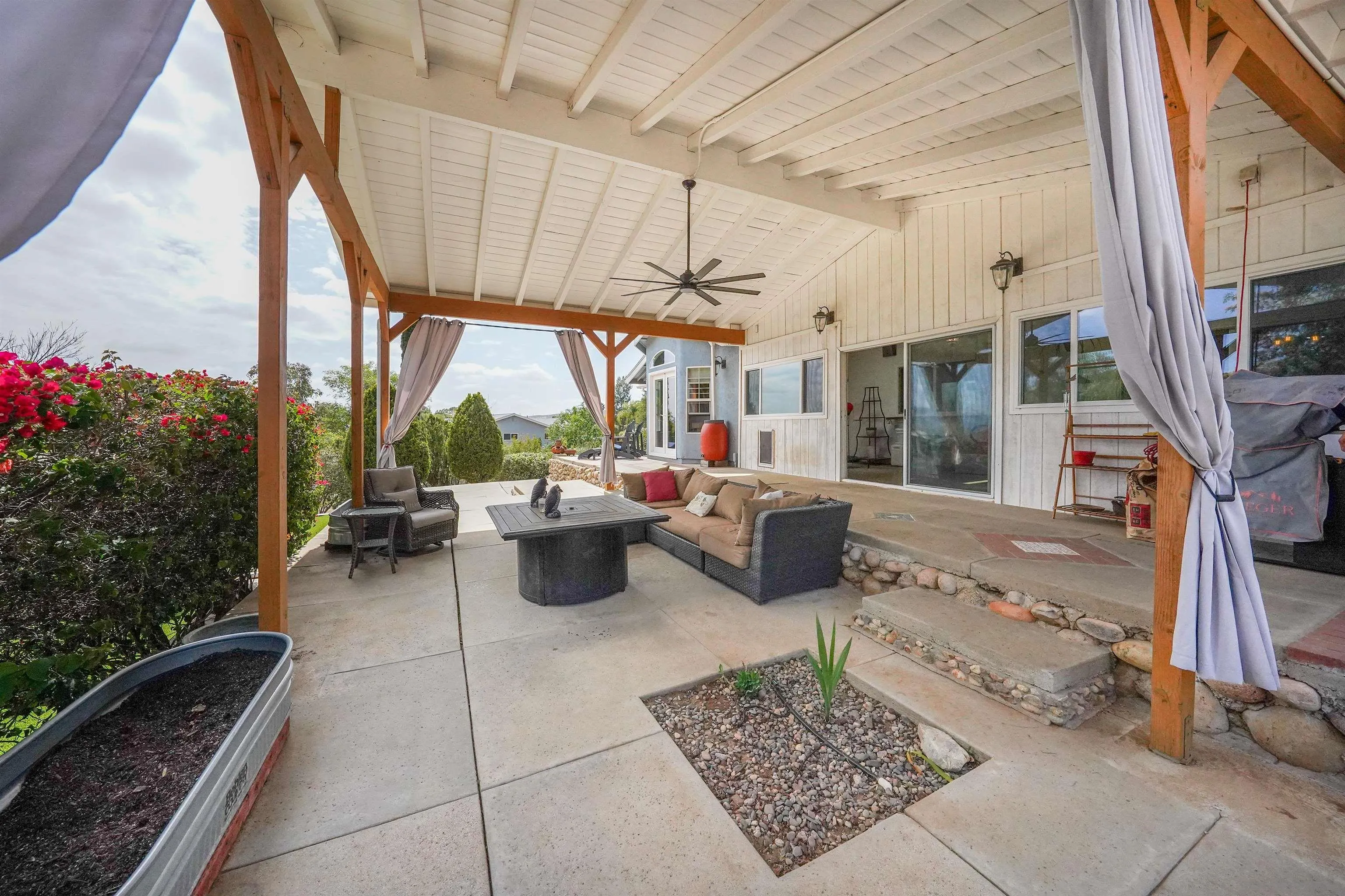 24563 Del Amo Road Ramona, CA 92065 - Photo 51 of 59 a view of a patio with table and chairs potted plants with wooden floor and seating space