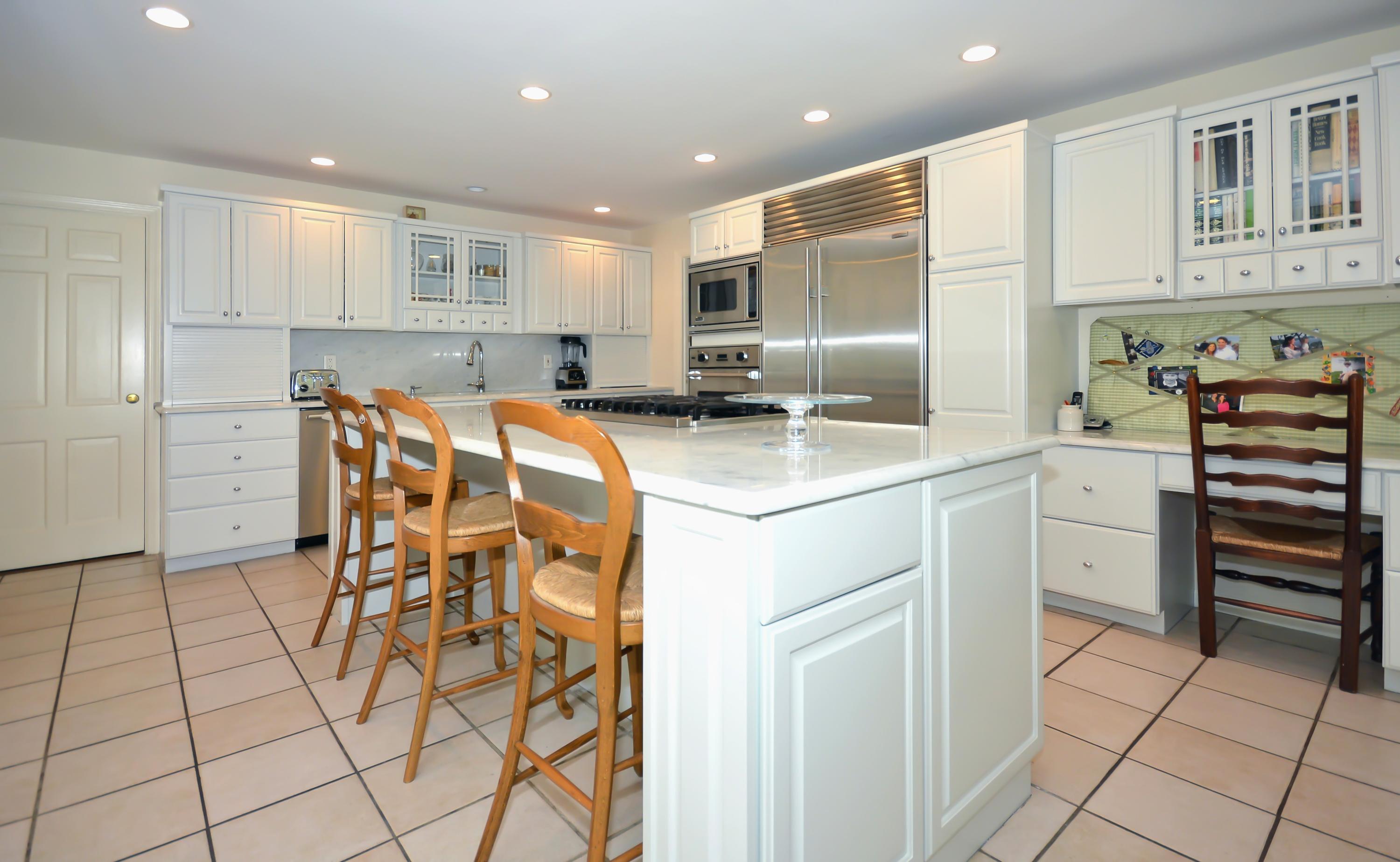 47 Delafield Island Road Darien, CT 06820 - Photo 13 of 26 a kitchen with stainless steel appliances kitchen island granite countertop a refrigerator and cabinets