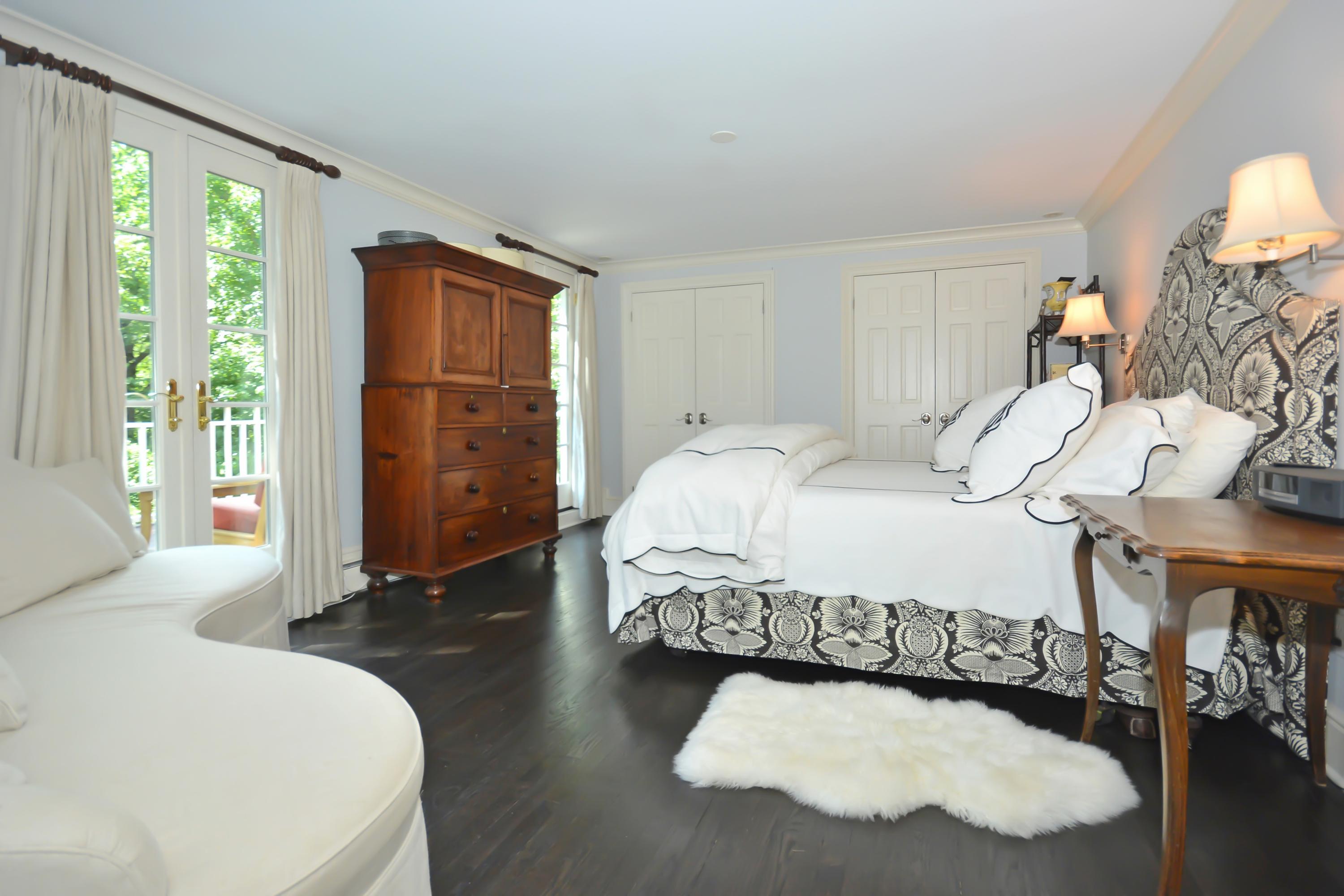 47 Delafield Island Road Darien, CT 06820 - Photo 15 of 26 a spacious bedroom with a bed and a window